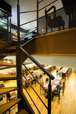 a staircase in a restaurant with tables and chairs at Maison du Cassoulet in Castelnaudary