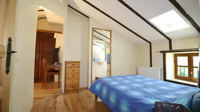a bedroom with a bed and a dresser and a mirror at Gite complex near Mirepoix in the Pyrenees in Limbrassac
