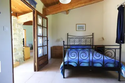 a bedroom with a black bed in a room at Gite complex near Mirepoix in the Pyrenees in Limbrassac
