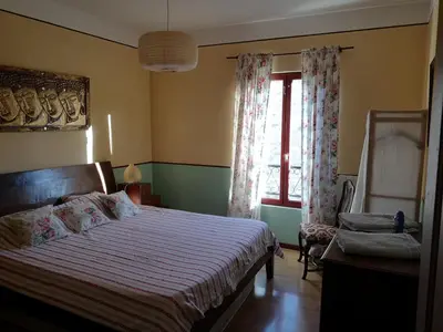 a bedroom with a bed and a window at L'Ours des Corbières - Chambres d'hôtes in Serviès-en-Val