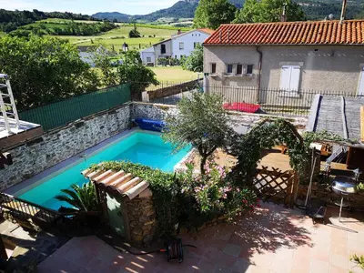 a swimming pool in the backyard of a house at L'Ours des Corbières - Chambres d'hôtes in Serviès-en-Val