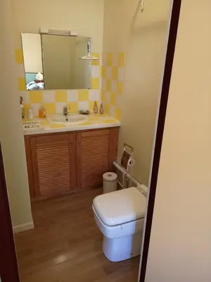 a bathroom with a toilet and a sink and a mirror at L'Ours des Corbières - Chambres d'hôtes in Serviès-en-Val