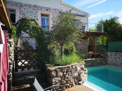 a villa with a swimming pool and a house at L'Ours des Corbières - Chambres d'hôtes in Serviès-en-Val