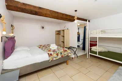 a bedroom with a bed and a bunk room at Le Grand Bassin in Castelnaudary