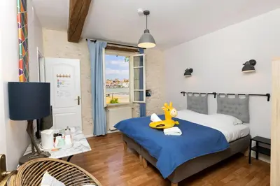 a bedroom with a bed with a yellow duck toy on it at Le Grand Bassin in Castelnaudary