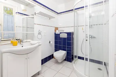 a bathroom with a toilet sink and a shower at Le Grand Bassin in Castelnaudary