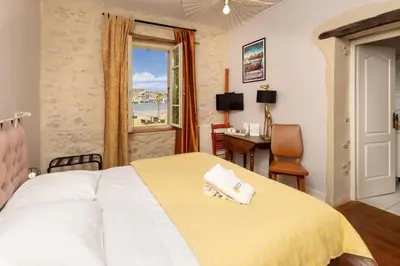 a bedroom with a bed and a desk and a window at Le Grand Bassin in Castelnaudary