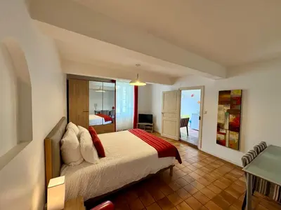 a bedroom with a bed with a view of the ocean at Studio au Coeur du Village avec terrasse et parking proche de Pamiers in Verniolle