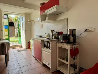 a kitchen with a sink and a stove top oven at Studio au Coeur du Village avec terrasse et parking proche de Pamiers in Verniolle