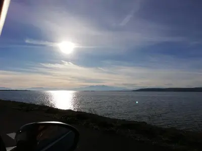a view of a large body of water with the sun at Maison près de la plage in Port-la-Nouvelle