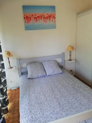 a bedroom with a bed with two pillows on it at Maison près de la plage in Port-la-Nouvelle