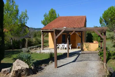 a gazebo with a table and chairs in a garden at FranceComfort - L'Espinet in Quillan