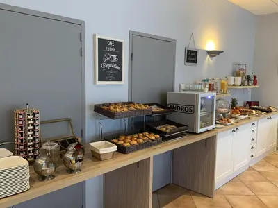 a kitchen with a counter with food on it at Hôtel La Bastide Saint Martin in Carcassonne