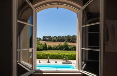 a room with two beds and a desk with a computer at Hôtel La Bastide Saint Martin in Carcassonne