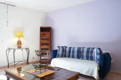 a living room with a couch and a coffee table at Jardin de Palme in Lapalme
