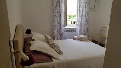 a bedroom with a bed with pillows and a window at Château La Villatade in Sallèles-Cabardès