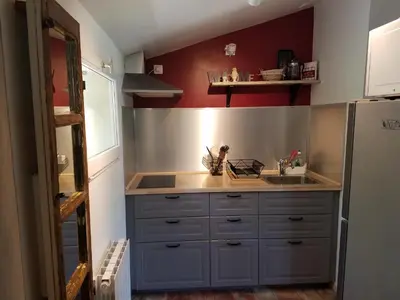 a kitchen with a sink and a refrigerator at Château La Villatade in Sallèles-Cabardès
