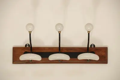 a shelf with three lights on a wall at La Maison Vieille Maison d'Hôtes & Gîtes in Carcassonne