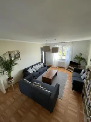 a living room with two couches and a coffee table at Le Gîte de la Bade in Villegailhenc