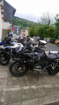 a row of motorcycles parked in a parking lot at Chez Charlotte et Michel in Brassac