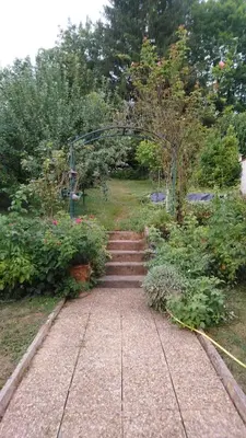 a set of stairs leading to a garden with a gate at Chez Charlotte et Michel in Brassac