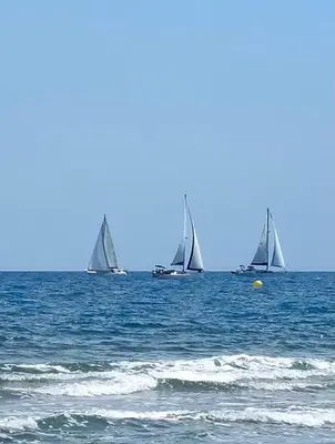 three sailboats in the ocean on the water at Studio Les Régates avec loggia et parking gratuit Plage du Grazel Gruissan in Gruissan