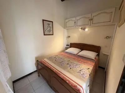 a small bedroom with a bed in a room at Villa T2 Mezzanine 4 pers avec Parking à La Franqui - FR-1-81-370 in La Franqui-Plage