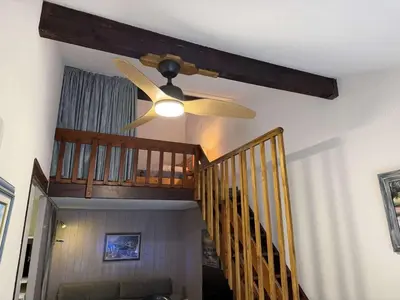 a ceiling fan in a living room with a staircase at Villa T2 Mezzanine 4 pers avec Parking à La Franqui - FR-1-81-370 in La Franqui-Plage