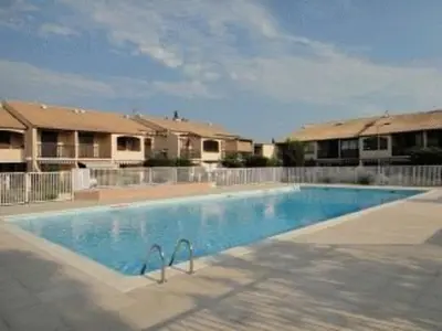 a large swimming pool in front of some apartments at Villa T2 Mezzanine 4 pers avec Parking à La Franqui - FR-1-81-370 in La Franqui-Plage