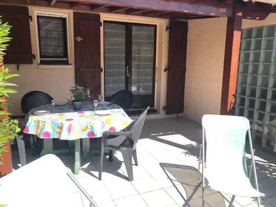 a table and chairs on a patio at Villa T2 Mezzanine 4 pers avec Parking à La Franqui - FR-1-81-370 in La Franqui-Plage