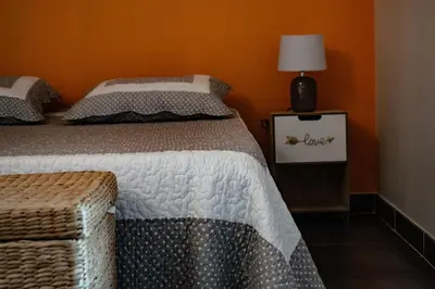 a bedroom with two beds and a table with a lamp at Chambre d'hôtes Lempery in Puéchoursi