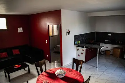 a living room with a table and a couch at Gîte Lempery in Puéchoursi