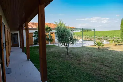 a view from the porch of a house with a yard at Gîte Lempery in Puéchoursi