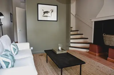 a living room with a white couch and a table at Château Canet in Rustiques