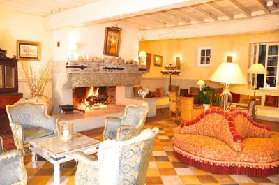 a bedroom with a canopy bed in a yellow room at Hôtel Château de Cavanac in Carcassonne