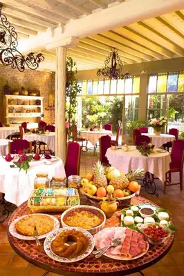 a table with many plates of food on it at Hôtel Château de Cavanac in Carcassonne