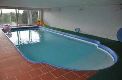 a large swimming pool in a room at Domaine de Hurlevent in Montgaillard-Lauragais
