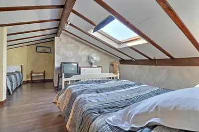 a attic bedroom with a bed and a tv at Domaine de Hurlevent in Montgaillard-Lauragais