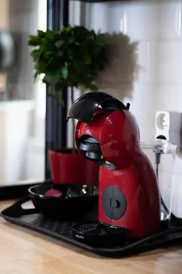 a red mixer sitting on a tray on a table at Le Temps d'Eugène Centre historique in Narbonne