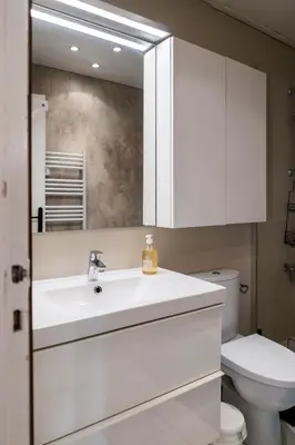 a bathroom with a white sink and a toilet at Le Temps d'Eugène Centre historique in Narbonne