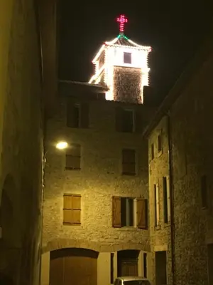 a building with a red cross on top of it at night at Studio du couvent des carmes in Narbonne