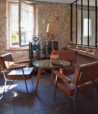 a dining room with a table and chairs at Les Treillettes in Puylaurens