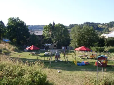 a park with tents and chairs in the grass at Chateau de Camurac in Camurac
