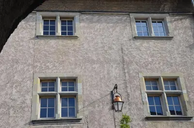 a building with four windows and a street light at Pelletier du Claux in Carcassonne