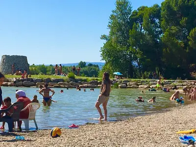 a group of people in the water at a beach at La Maison du Canal - Canal Studio in Homps