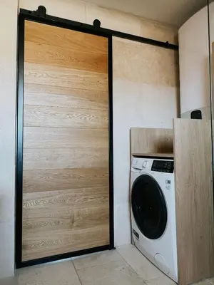 a door to a laundry room with a washing machine at Domus Via Domitia in Narbonne