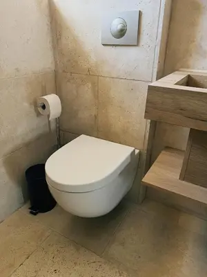 a bathroom with a toilet and a roll of toilet paper at Domus Via Domitia in Narbonne