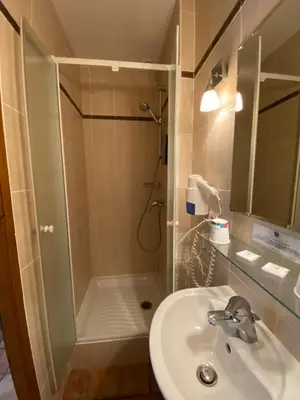 a bathroom with a shower and a sink at Auberge la Table du Curé in Cucugnan