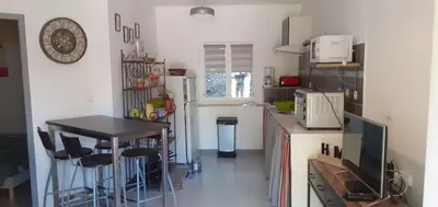 a small kitchen with a table and a counter top at Château Haut Gléon in Villesèque-des-Corbières