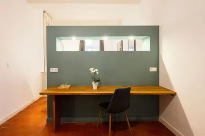 a table in a room with a chair and a mirror at Château Haut Gléon in Villesèque-des-Corbières